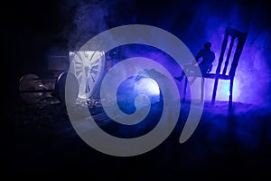 Time concept. Silhouette of a man standing between hourglasses with smoke and lights on a dark background. Surreal decorated