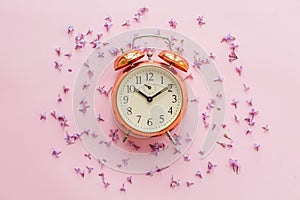 Time concept. stylish vintage alarm clock on pink background wit