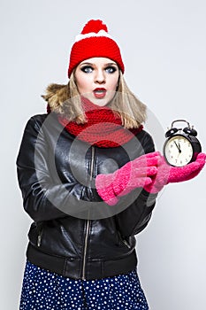 Time Concepts. Portrait of Exclaiming  Caucasian Blond Girl In Warm Hat and Scarf Posing With Surprised Facial Expression and