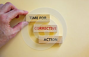 Time for corrective action symbol. Wooden blocks with words `Time for corrective action` on a beautiful white background.