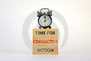 Time for corrective action symbol. Wooden blocks with words `Time for corrective action` on a beautiful white background. Black