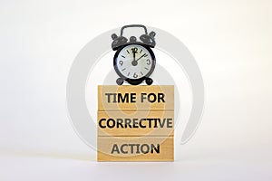 Time for corrective action symbol. Wooden blocks with words `Time for corrective action` on a beautiful white background. Black