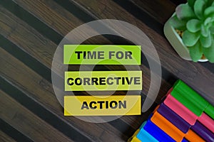 Time For Corrective Action write on sticky notes isolated on Wooden Table