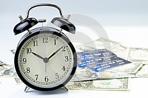 Time countdown or deadline to pay for credit card debt, financial problem habit concept, alarm clock with pile of credit cards on