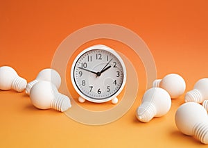 Time,dateline and creativity concepts with group of lightbulb and clock on pastel color