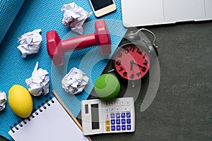 Time for exercising clock, dumbbell, yoga mat