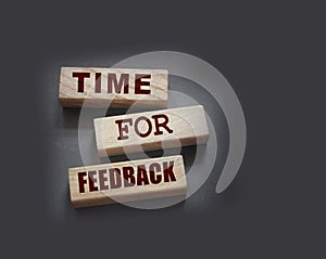 Time fir feedback text on wooden blocks. Product or service evaluation and clients feedback in business concept