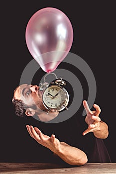 Time flies concept - picture of a man in panic trying to grab an old metal clock