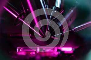 Time of flight mass spectrometer in closeup shot with purple and pink light