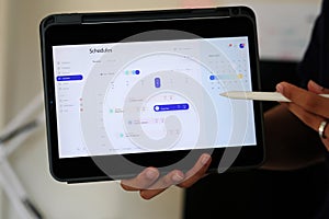 Time frame planner on digital tablet screen for mobile phone app delveloper team at home office
