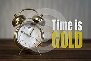 Time is gold concept - golden alarm bell clock