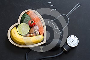 Time for health heart abstract diet food concept on blackboard with bell