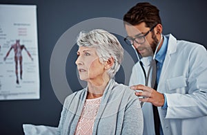 Time for her routine checkup. a doctor examining a senior patient with a stethoscope in a clinic.