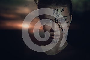 Time keeper. watchman. woman with watch on face at sunset