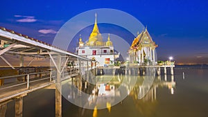 Time laps of temple above sea with cloudy at night time