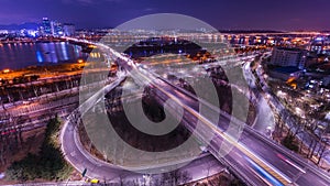 Time lapse of bridges and Cars passing in intersection, Han Riverside at Night in Downtown Seoul, South Korea. 4K