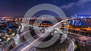 Time lapse of bridges and Cars passing in intersection, Han Riverside at Night in Downtown Seoul, South Korea. 4K