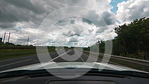 Time lapse of the car riding by speedway at sunny cloudy day