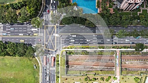 Time-lapse of car traffic above cross road junction in Singapore city residential district area. Drone aerial top view