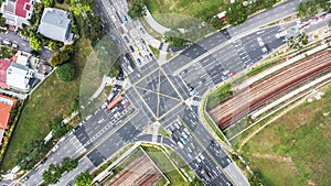 Time-lapse of car traffic above cross road junction in Singapore city residential district area. Drone aerial top view