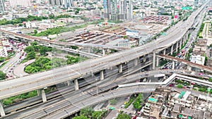 Time-lapse of car traffic transportation on elevated highway, road intersection, sky train railway, with under construction site