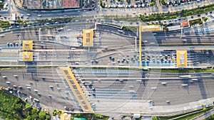 Time-lapse of car traffic transportation on multiple lanes highway road and toll collection gate, drone aerial top view