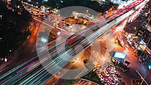 Time-lapse of car traffic transportation on road at junction intersection in Asia urban city, night cityscape high angle view