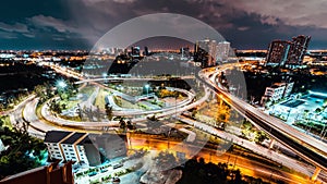 Time-lapse of car traffic transportation on winding highway road intersection in Bangkok city Thailand at night
