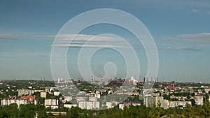 Time-lapse cityscape with smoking pipes of metallurgical plant.