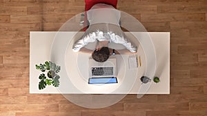 Time lapse clip of casually dressed business man is sleeping on the desk in front of his laptop in a light wooden office