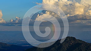 Time-lapse of cloud with rain and rainbow over mountain at Khao Kho, Phetchabun, Thailand