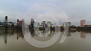 Time lapse of clouds and auto traffic downtown Portland Oregon with city skyline and water reflection