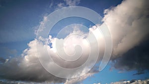 Time-lapse of clouds moving in blue sky