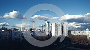 Time lapse of clouds over the city and the construction site in early spring.