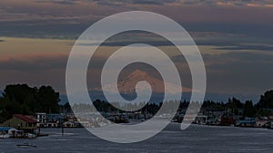 Time lapse of clouds over mt. hood and Columbia river with boathouses in Hayden Island