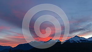 Time lapse of clouds over Tantalus Range in BC Canada at colorful sunset UHD