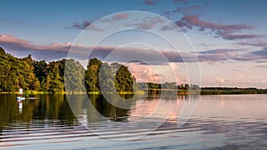 Time lapse of clouds passing near lake, sunset time and clouds reflection