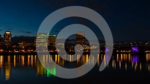 Time lapse of clouds and traffic Portland Or with water reflection at night 4k