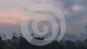 Time-lapse of cloudy Kuala Lumpur city centre skyline during sunrise