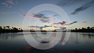 Time lapse of colorful sunset over calm lake in Everglades National Park 4K.