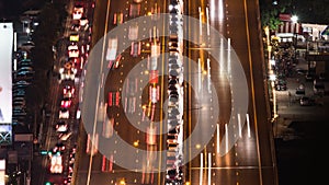 Time-lapse of crowded car traffic transportation on elevated highway or expressway road at night. Urban transport lifestyle