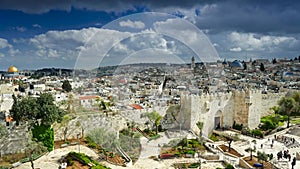 Time lapse of Damascus Gate and old Jerusalem City. People walk in the park entering the old city of Jerusalem through