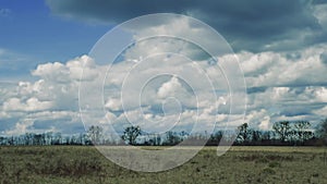 Time lapse of dramatic scenic cloudscape with beautiful cumulus clouds moving in countryside over a field in autumn