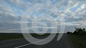 TIME LAPSE - an empty asphalt road between the fields