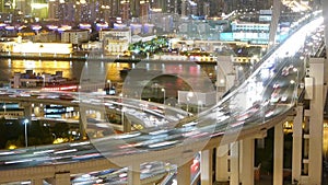 Time lapse fast cars on overpass bridge,urban building & shipping on river.