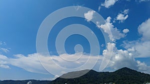 time lapse Fast moving clouds against a nice blue sky with Palm Tree and swaying in the wind Patong Phuket Thailand