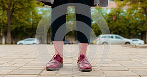 Time lapse of the feet of a girl which is standing in the middle of a clean park