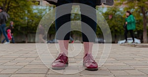 Time lapse of the feet of a girl which is standing in the middle of a green park