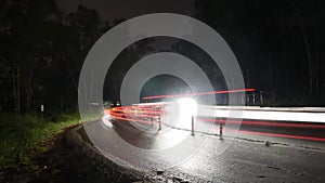 Time lapse footage of vehicles passing through forest