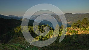 Time-lapse of light and shadow changing in mountains and woods at dawn